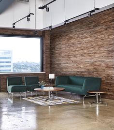 a room with chairs and a table in front of a large window