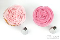 two cupcakes with pink frosting on top and white icing in the middle