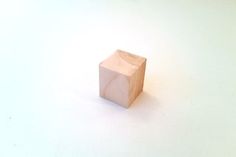 a wooden block sitting on top of a white surface