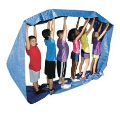 several children are playing on a trampoline with their hands up in the air