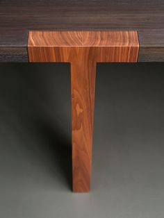 a close up of a wooden table on a gray background