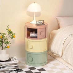 a bedroom with a bed, nightstand and lamp on the side table in front of it