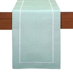 a light green table runner with white trim