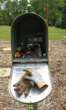 an open mailbox with gardening tools in it and the words put a mailbox in your garden to store your tools