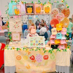 a table with many items on it and people standing around the table looking at them