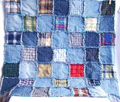 a blue patchwork quilt is hanging on the wall