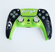 a green and black game controller with writing on it's side that says rock n roll