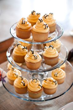 cupcakes are arranged on three tiered plates