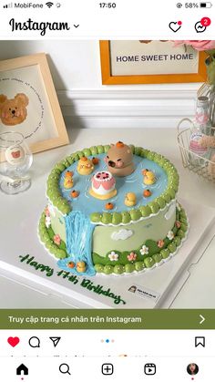 a cake decorated with teddy bears in a pond on top of a white countertop