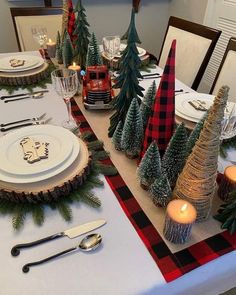 a table set for christmas with place settings