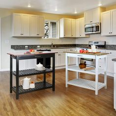 a kitchen with white cabinets and wooden floors