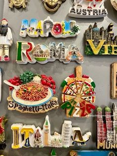 there are many magnets on the wall that say italy and other countries in different languages