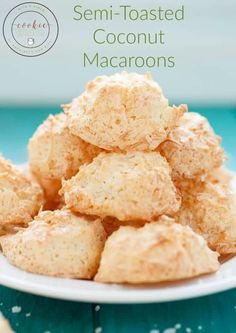 a white plate topped with coconut macaroons on top of a blue tablecloth