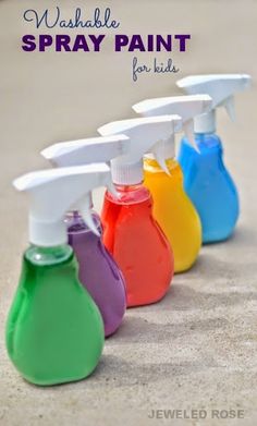 spray bottles filled with different colors of paint on the sand and text overlay that says washable spray paint for kids