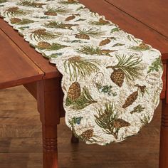 a table runner with pine cones on it