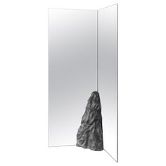 a mirror with a rock sticking out of it