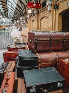 many suitcases are stacked on top of each other