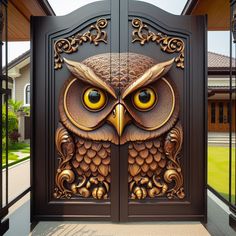 an owl is on the front door of a house with ornate carvings and gold eyes