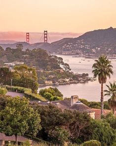 the golden gate bridge in san francisco, california is seen from across the bay at sunset