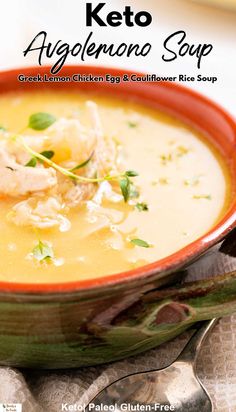 a close up of a bowl of soup with broth and garnishes