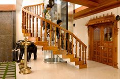 an elephant statue in front of a wooden staircase