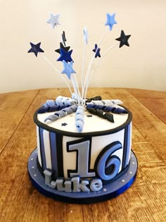 a birthday cake decorated with blue and white stars