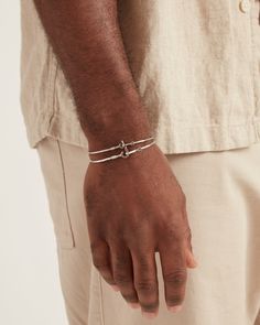 A Vibe signature, this slimmest version of the St. John Hook Bracelet is fashioned in gently hammered sterling silver with a "J" hook clasp to honor the island of St. John. Featuring a tiny replica of the St. John petroglyph and seven good luck wraps, solo or stacked, it is sure to be a favorite piece. Found in many of our designs, Vibe’s seven good luck wraps represent love, laughter, happiness, good fortune, health, unity, and peace. In the Caribbean tradition, wear your hook facing in to keep Minimalist Adjustable Sterling Silver Bracelet With Lobster Clasp, Adjustable Sterling Silver Bracelet With Polished Finish For Everyday, Adjustable Hammered Sterling Silver Minimalist Bracelet, Adjustable Engraved Sterling Silver Bracelet For Everyday, Adjustable Engraved Sterling Silver Everyday Bracelet, Engraved Adjustable Sterling Silver Bracelet For Everyday, Engraved Sterling Silver Bracelet Everyday, Hook Bracelet, Hammered Sterling Silver