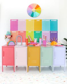 the colorful lockers are next to each other in front of a wall with calendars on it