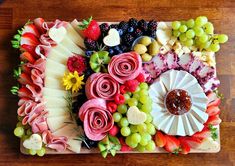 a platter filled with lots of different types of food on top of a wooden table