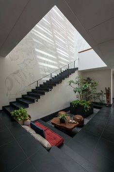 an indoor living room with stairs and plants