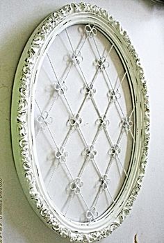 an ornate white frame hanging on the wall