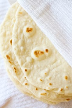 three flat breads are sitting on a towel