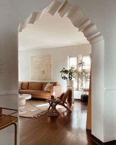 a living room filled with furniture and a wooden floor