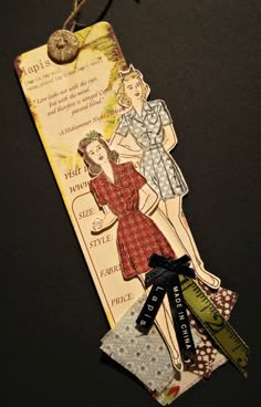 a bookmark with an image of a woman in a dress and some tags attached to it