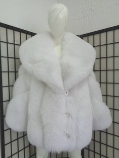 "BEAUTIFUL & VERY STYLISH NATURAL WHITE FOX FUR JACKET FOR WOMEN, MADE FROM FULLY LET OUT SKINS; THE BEST! THE COLLAR IS \"SHAWL\" TYPE AND VERY BIG. THE SLEEVES ARE DIAGONAL, IT CLOSES WITH BUTTONS AND HAS TWO SIDE POCKETS. THIS ITEM IS BRAND NEW/MADE TO MEASUREMENT! AFTER BUYING THIS ITEM, IT WOULD BE VERY MUCH APPRECIATED IF YOU COULD PROVIDE YOUR HEIGHT, WEIGHT AND BUST CIRCUMFERENCE, SO WE CAN MAKE THE COAT TO YOUR SIZE.  MEASUREMENTS:   *SIZE: WILL BE MADE TO MEASUREMENT *LENGTH: 30\"  *SL Luxury Winter White Outerwear With Faux Fur Lining, Luxury Fitted Winter White Fur Coat, Luxury Winter White Faux Fur Coat, Luxury Long Winter White Fur Coat, Luxury Winter White Chic Fur Coat, Luxury White Fitted Fur Coat, Fox Racing Clothing Coats Women, Luxury White Fur Coat For Cold Weather, Cheap Playful White Outerwear