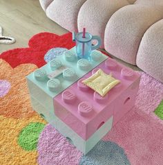 a pink and blue lego table on the floor