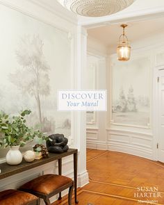 a room with white walls and wood flooring has a wallpaper that says discovery your mind