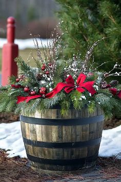 a wooden barrel filled with lots of christmas decorations