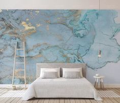 a bedroom with blue and gold marble wallpaper