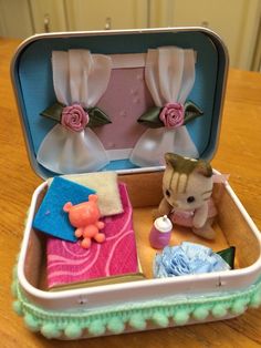 an open suitcase filled with toys on top of a wooden table