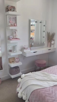 a bedroom with a bed, mirror and shelves on the wall next to each other