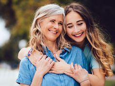 two women hugging each other and smiling