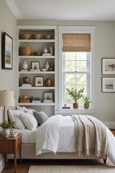 a white bed sitting under a window in a bedroom