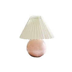 a pink table lamp sitting on top of a white floor