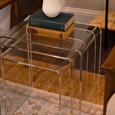 a stack of books sitting on top of a glass table