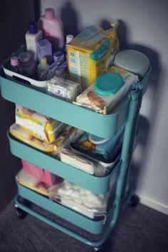 a blue cart filled with lots of different types of baby goods and condiments