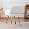 a white chair sitting on top of a hard wood floor next to a book shelf