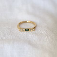 a gold ring with three stones on it