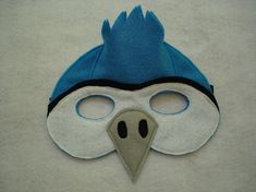 a close up of a mask with a bird on it's face and eyes