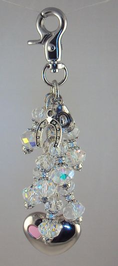 a close up of a keychain with beads and charms on it's side